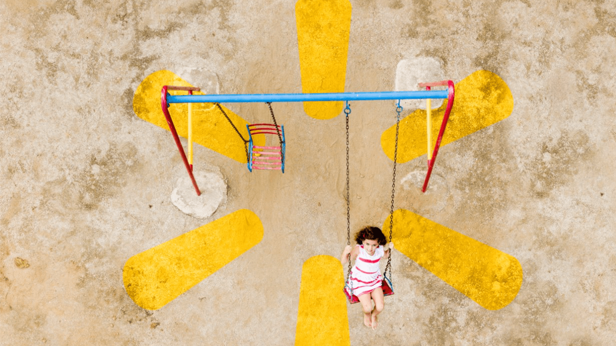 Child swinging on playset on top of Walmart brand logo